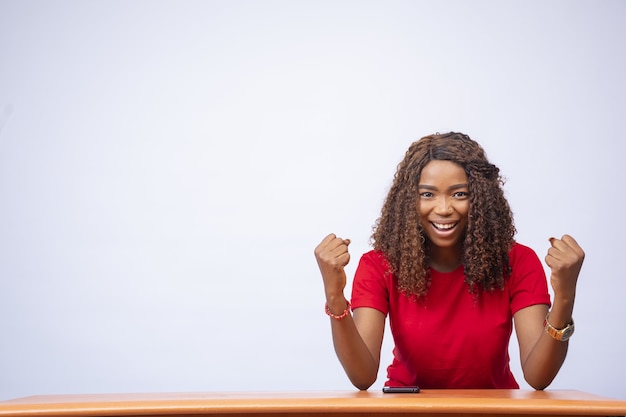 Celebrating Young Woman at Desk – Free Stock Photo for Download