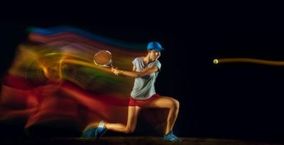 One Woman Playing Tennis Isolated on Black Wall in Mixed and Strobe Light – Free Download