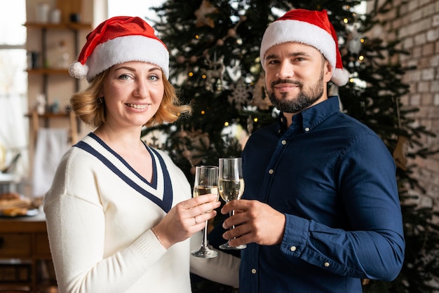 Wife and Husband Celebrating Christmas with Champagne Glasses – Free Download