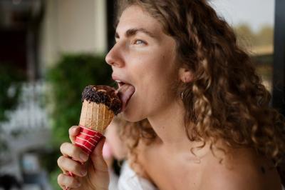 Side View of a Woman Enjoying an Ice Cream Cone – Free Download