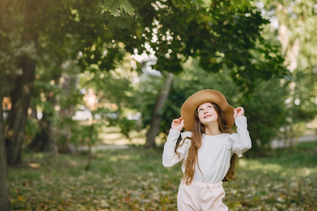 Little Girl in a Brown Hat Playing in the Park – Free Download