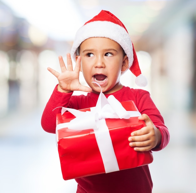 Boy Holding a Gift with a White Bow – Free Stock Photo for Download