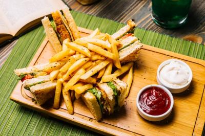 Delicious Club Sandwich with Toasted Bread, Chicken, Tomato, Cucumber, and French Fries – Free Stock Photo for Download