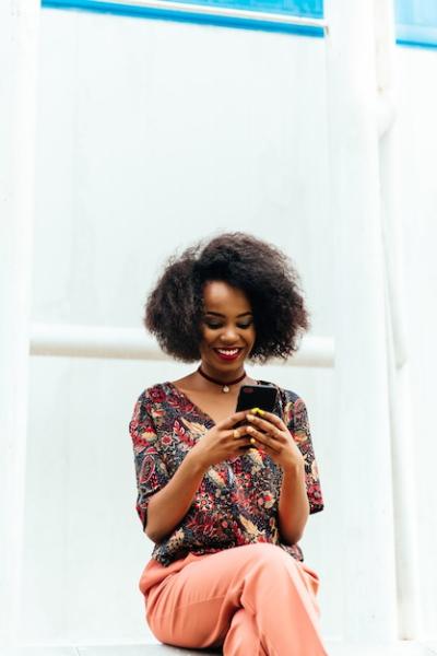 Charming Afro-American Woman Smiling at Smartphone – Free Stock Photo, Download Free