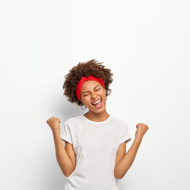 Triumphant Afro Girl Smiling with Joy – Free Stock Photo for Download