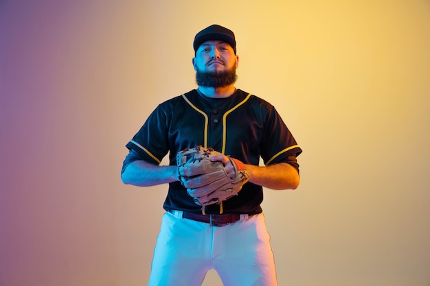 Pitcher in Black Uniform Practicing Against Neon Background – Free Download