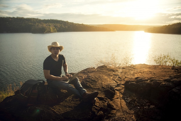 Backpacker Relaxing on Mountain with Laptop – Free Stock Photo for Download