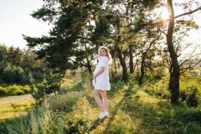 Pregnant Woman Strolling in a Park at Sunset – Free Download, Download for Free