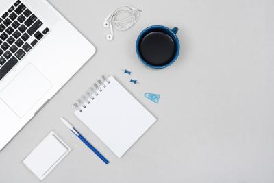 Laptop, Coffee Cup & Office Stationery on a Gray Business Desk – Free Stock Photo for Download