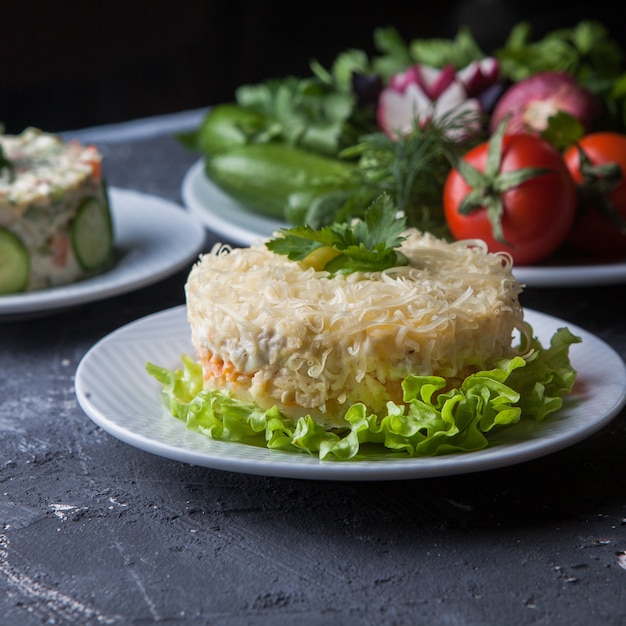 Side View of Mimosa Salad with Olivier Salad, Tomato, and Cucumber – Free Download