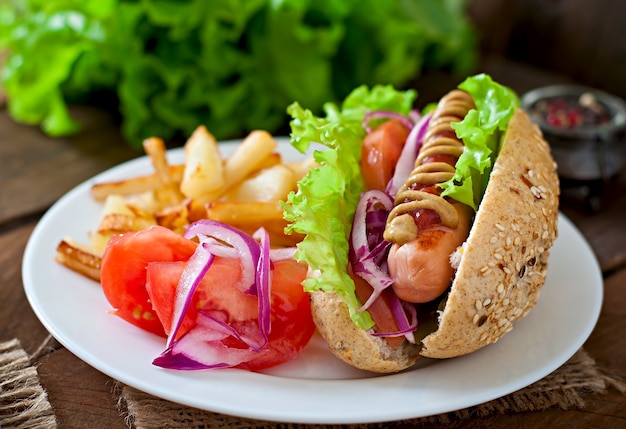 Hotdog with Ketchup, Mustard, and Lettuce on Wooden Table – Free Download