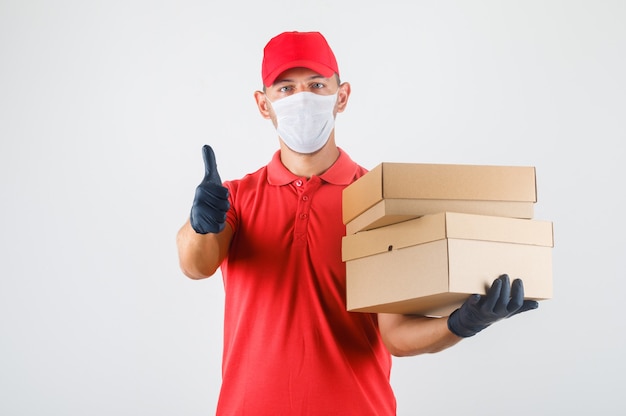 Delivery Man in Red Uniform with Medical Mask and Gloves – Free Stock Photo for Download