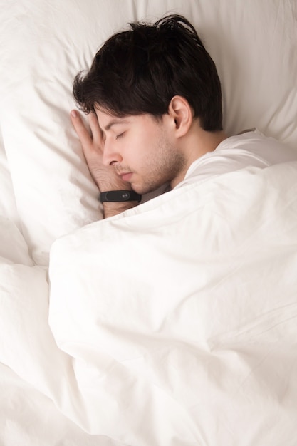 Young Guy Sleeping in Bed with Smart Watch – Free to Download Stock Photo