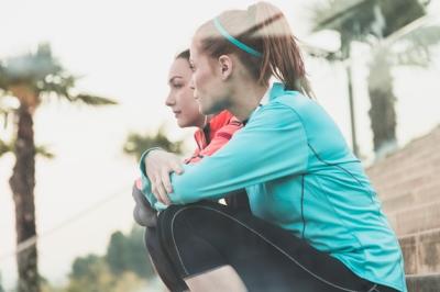 Calm Sportswomen Sitting on Stairs – Free Stock Photo for Download