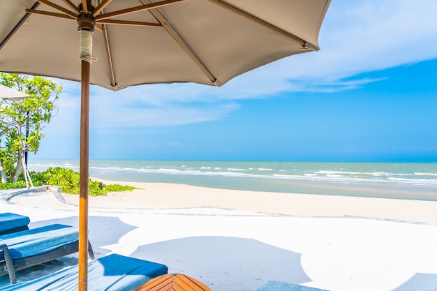 Umbrella and Chair by the Ocean with Blue Sky and White Clouds – Free Download