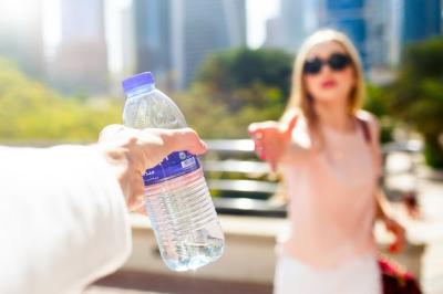 Girl Reaching for a Bottle of Water – Free Download