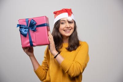 Young Woman in Santa Hat Holding Gift Box – Free Stock Photo, Download for Free