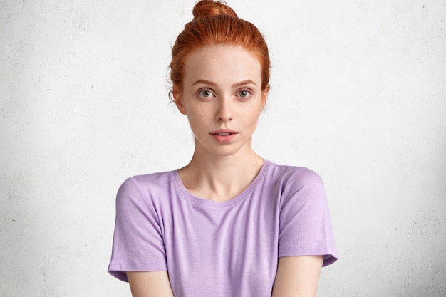 Confident Young Ginger Female in Casual Purple T-Shirt – Free Stock Photo for Download