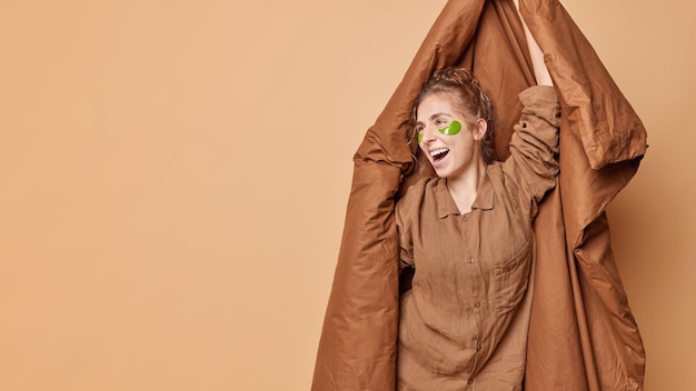 Cheerful Young Woman with Hydrogel Patches in Nightwear – Free Stock Photo for Download