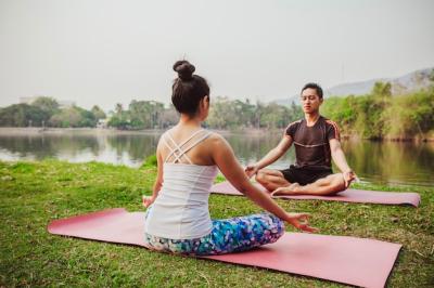 Modern Couple Meditating Next to the Lake – Free Download