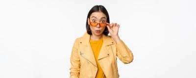 Portrait of an Asian Brunette Woman in Stylish Sunglasses with a Surprised Expression – Free Stock Photo for Download