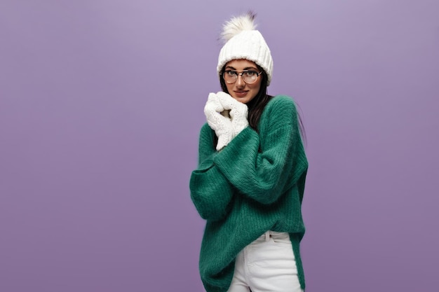 Shy Cute Woman in Stylish Woolen Green Sweater Posing on Purple Background – Free Stock Photo, Download for Free