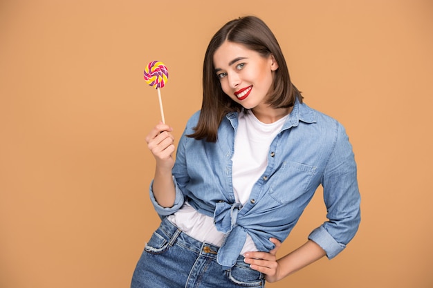 Colorful Lollipop Held by Young Woman – Free Download