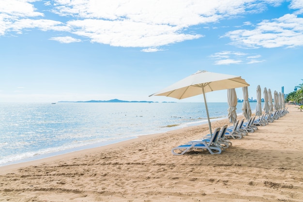 Outdoor Scene Featuring Umbrella and Chair on a Beautiful Tropical Beach – Free Download