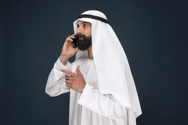 Half-Length Portrait of Saudi Arabian Man Using Smartphone – Free Stock Photo for Download