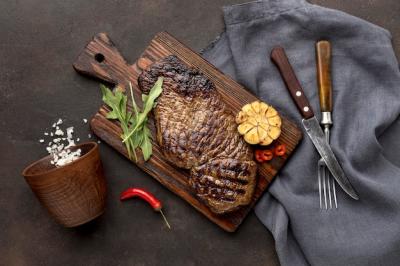 Grilled Meat on Wooden Board with Cutlery – Free Download