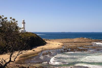 Stunning High Angle View of a White Lighthouse by the Sea – Free Download