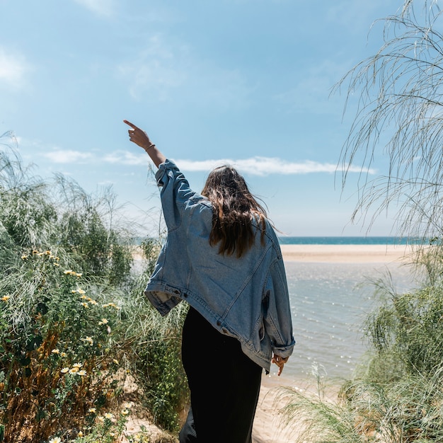 Woman with Raised Hand in Tropical Bushes – Free Stock Photo for Download