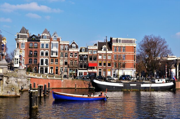 Sailboats Moored on Canal by City Buildings – Free Stock Photo for Download