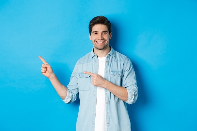 Smiling Caucasian Man in Casual Outfit Pointing Left – Free Stock Photo, Download Free