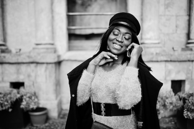 African American Woman in Violet Dress and Cap Posed Outdoors – Free Download