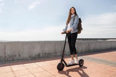 Young Woman Riding a Scooter Outdoors – Download Free Stock Photo