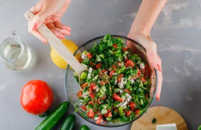 Woman Preparing Vegetable Salad with Tomatoes, Cucumber, and Lemon – Free Download