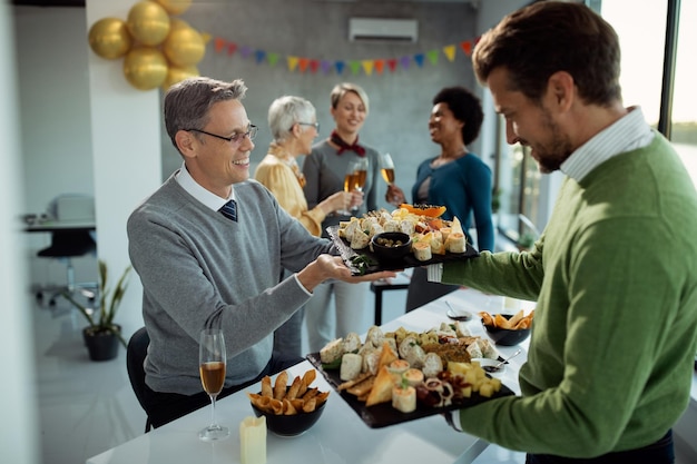 Happy Male Entrepreneurs Preparing for an Office Party – Free Download