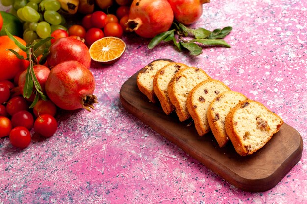 Delicious Fruit Composition with Sliced Cakes on Light Pink Desk – Free Download