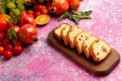 Delicious Fruit Composition with Sliced Cakes on Light Pink Desk – Free Download