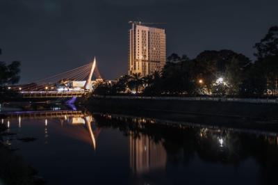 Illuminated Buildings Reflected in Water at Night – Free Download