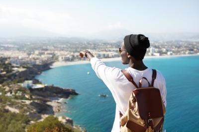 Unrecognizable Young African Man in Hipster Hat Admiring Sea and Resort Town – Free Download