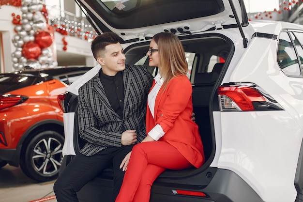 Stylish and Elegant Couple in a Car Salon – Free Stock Photo for Download