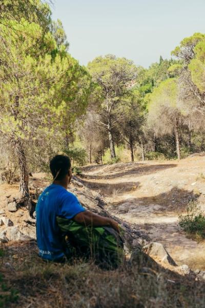 Backpacker Sitting in Shadows – Free Stock Photo for Download