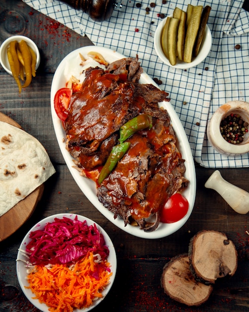 Top View of Iskender Kebab Garnished with Tomato Sauce – Free Download