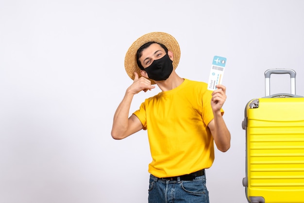 Young Man in Yellow T-Shirt with Suitcase and Travel Ticket – Free to Download