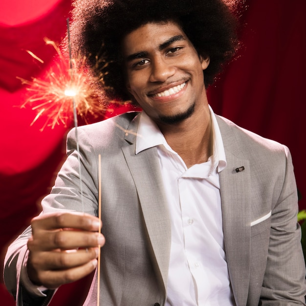 Celebratory Moment: Man Holding a Burning Sparkler Blast – Download Free Stock Photo