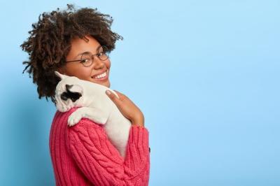 Happy Dark Skinned Woman Playing with Pedigree Puppy – Free Download