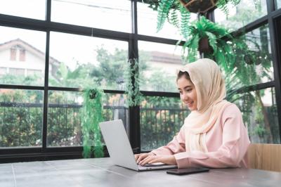 Beautiful Young Smiling Asian Muslim Woman Working on Laptop at Home – Free Stock Photo, Download for Free