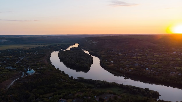 Sunrise Over a Moldovan Village Featuring an Orthodox Church and a River – Free Download